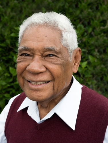 Senior man with Indonesian heritage smiles for the camera in profile photo. - Australian Stock Image