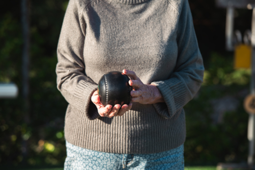 senior woman holding lawn bowls ball - Australian Stock Image