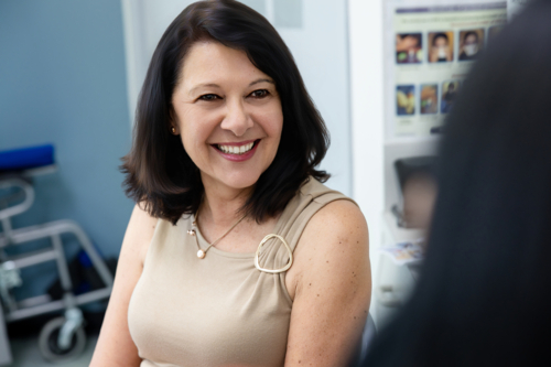 Senior woman patient smiling at the doctor - Australian Stock Image