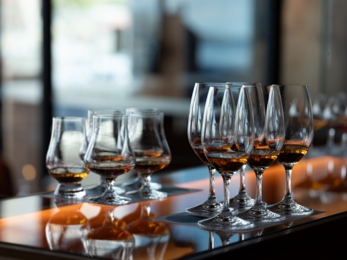 Series of glass wares filled with whisky for tasting - Australian Stock Image