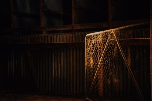 Shadow and light on a farm shed and gate - Australian Stock Image