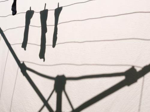 Shadow on a sheet of socks hanging on a clothes line