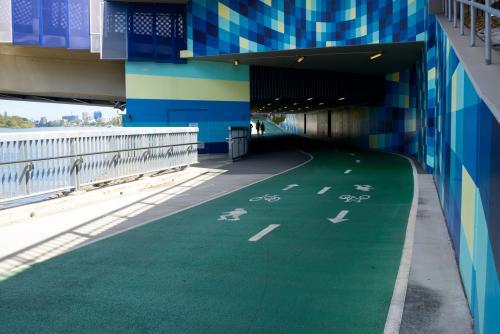 Shared bike and footpath with people silhouetted in background at end of underpass. - Australian Stock Image