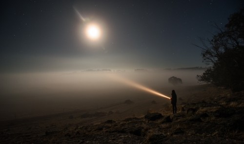 Shining torch into heavy fog close up - Australian Stock Image