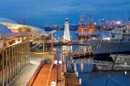 Ships and boats docked near the National Maritime Museum Lighthouse at Darling Harbor - Australian Stock Image
