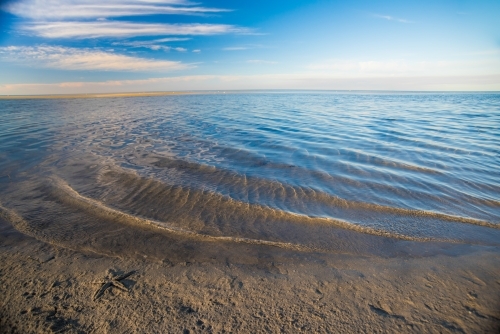Shore at the edge of a muddy patch at low tide - Australian Stock Image