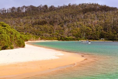 Shoreline and fishing vessel at Cockle Creek, Tasmania - Australian Stock Image