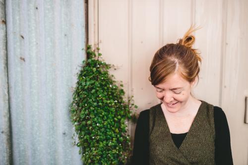 Shy woman in laneway looking down - Australian Stock Image