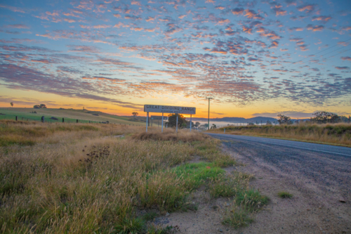 sign on early morning beside country road - Australian Stock Image