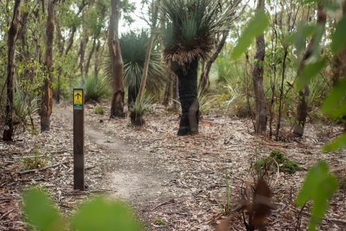 Sign on wooden post along bushwalking trail - Australian Stock Image