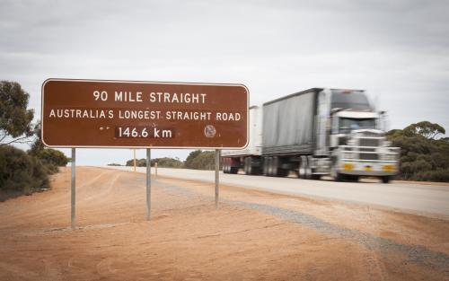 Signage of Australia's longest straight road and road train on the nullarbor