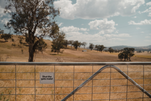 Signage on a wire farm gate in regional Australia - Australian Stock Image