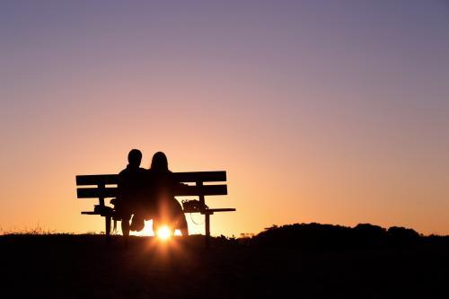 Silhouette of a couple at sunset - Australian Stock Image