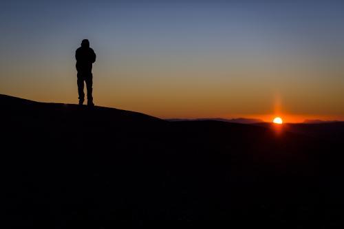 Silhouette of a hiker at sunrise - Australian Stock Image