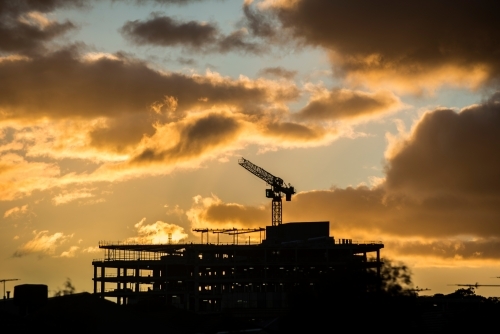 Silhouette of building site at sunset