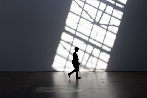 Silhouette of person and shadows at Carriage Works, Sydney - Australian Stock Image