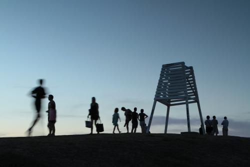 Silhouettes of people on a hilltop at dusk