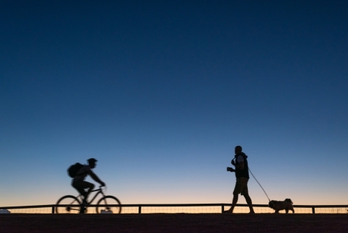 Silhouettes of people starting their day. - Australian Stock Image