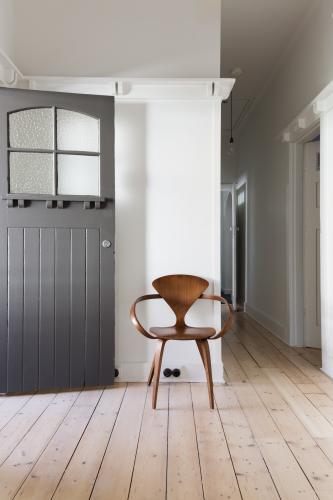 Simple decor of classic wooden chair in renovated apartment entry