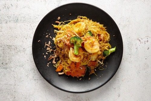Singapore noodles dish on table