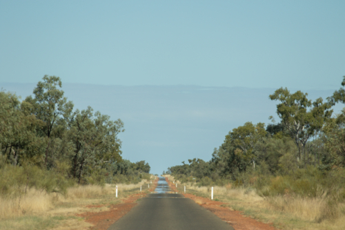 Single lane bitumen road in the outback, with mirage ahead - Australian Stock Image