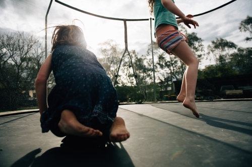 Sisters bouncing on trampoline