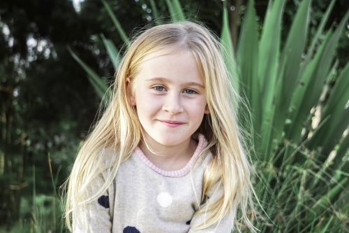 Six year old girl with blonde hair smiling - Australian Stock Image
