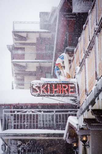 Ski hire sign on building in the snow - Australian Stock Image