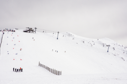 Ski lift and ski run with race course marked out - Australian Stock Image