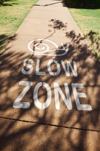 Slow Zone Sign painted on footpath - Australian Stock Image