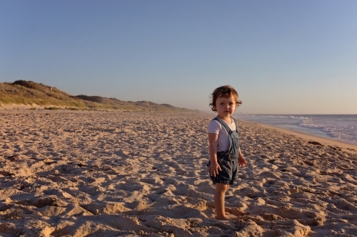 Small Child On The Beach At Sunset - Australian Stock Image