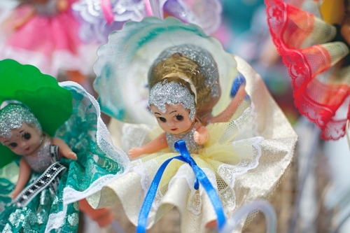 Small figurine dolls wearing colourful dresses - Australian Stock Image