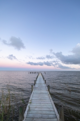 small jetty on lake at sunset - Australian Stock Image