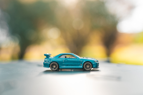 Small toy car close up outdoors with bokeh background - Australian Stock Image