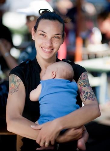 Smiling Aboriginal Woman Holding Baby - Australian Stock Image
