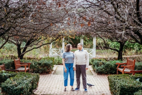 Smiling lgbtqi couple holding hands while looking at each other - Australian Stock Image
