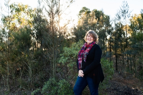 Smiling woman wearing bright scarf in winter - Australian Stock Image