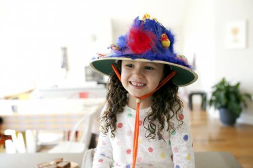 Smiling young girl with hand made easter hat
