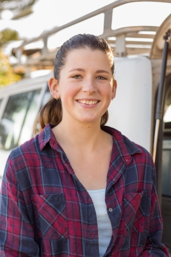 Smiling young woman wearing flannel shirt