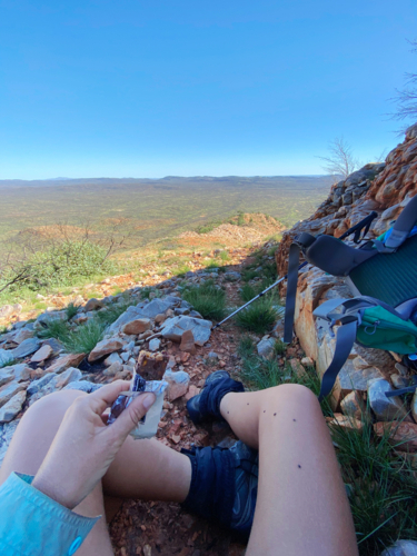 Snack break on a desert mountain hike - Australian Stock Image