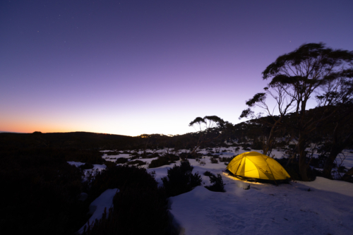 Snow camping at Phillack Saddle, looking towards Mt Baw Baw at dusk on a cool winter's night - Australian Stock Image