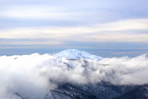 Snow mountain through fog - Australian Stock Image
