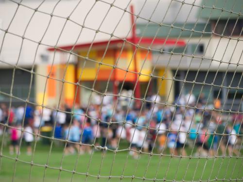 Soccer net with out of focus crowd in the background - Australian Stock Image