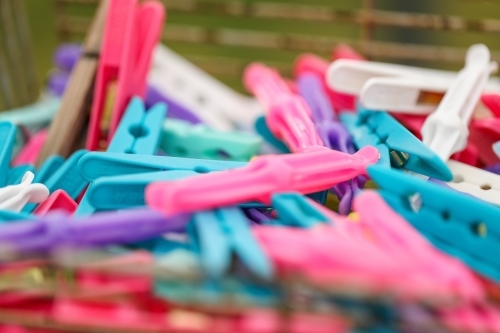 Soft focus close up of brightly coloured laundry pegs - Australian Stock Image