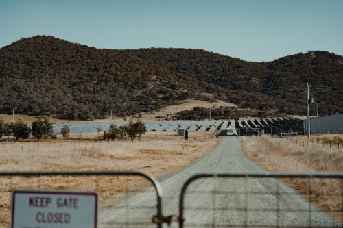 Solar farm panels for renewable energy behind a closed gate. - Australian Stock Image