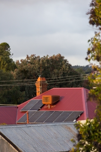 solar panels on a corrugated roof in a rural town