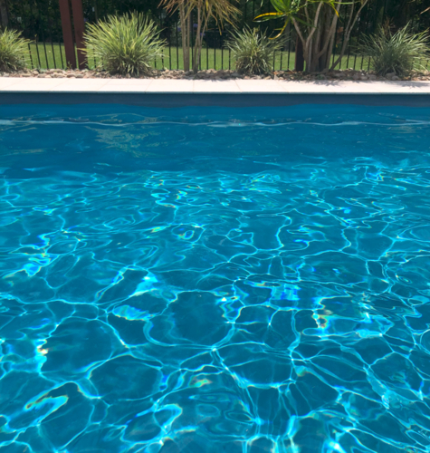 Sparkling blue pool water in backyard - Australian Stock Image