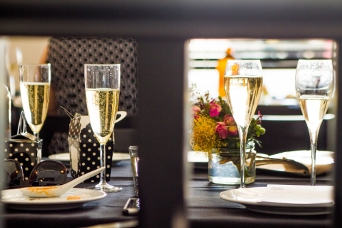 Sparkling Wine Glasses on restaurant table - Australian Stock Image
