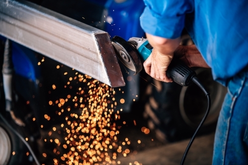 Sparks flying from a grinder grinding steel - Australian Stock Image