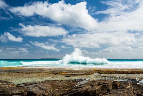 Spectacular view of surf crashing behind rock pools and dramatic sky - Australian Stock Image